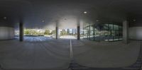 a view of a building with a glass roof from inside it and in the middle of the room