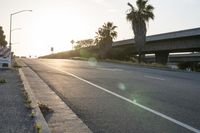 an empty street in a city at sunset with an overpass above the highway to allow traffic