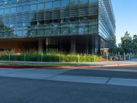 two grey blocks sitting next to a tall building on a sidewalk in front of grass