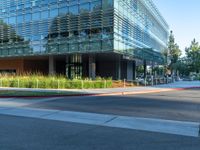 two grey blocks sitting next to a tall building on a sidewalk in front of grass