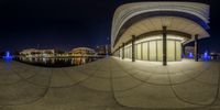 a 360 lens shot of the city at night, taken from below with a fisheye effect