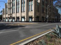 empty streets with stop lights on each side of them in the afternoon and a light pole on one end