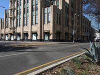 empty streets with stop lights on each side of them in the afternoon and a light pole on one end