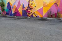 the exterior of a parking lot with a large wall mural on the side of it