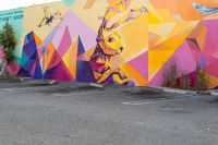 the exterior of a parking lot with a large wall mural on the side of it