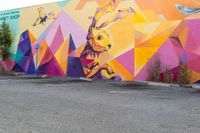 the exterior of a parking lot with a large wall mural on the side of it