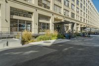 some parking lots and a building with windows and balconies in the street on an empty street