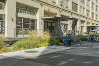 some parking lots and a building with windows and balconies in the street on an empty street