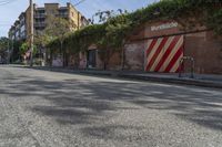 a city street with a long row of buildings lining it, including an iron bike rack on a sidewalk