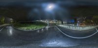 two photos of an asphalt road and some buildings with a street light at night behind them