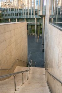 this stairs leads to two stories of building with large glass windows in front of it