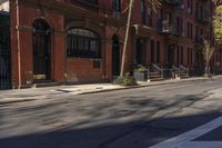 a street with brick buildings next to a white car on a street side walk in the city