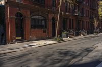 a street with brick buildings next to a white car on a street side walk in the city