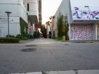 a fire hydrant near a building with graffiti written on it in a city area