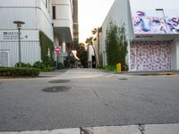 a fire hydrant near a building with graffiti written on it in a city area