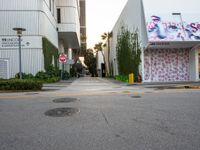 a fire hydrant near a building with graffiti written on it in a city area