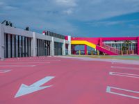 the red concrete floors and pink buildings are painted red with arrows pointing to different directions