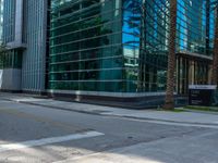 street view of office buildings and parking lot with no curbing at the intersection of city street