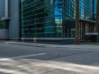 street view of office buildings and parking lot with no curbing at the intersection of city street