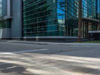 street view of office buildings and parking lot with no curbing at the intersection of city street