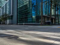 street view of office buildings and parking lot with no curbing at the intersection of city street