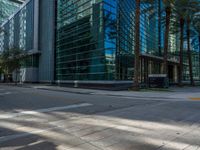 street view of office buildings and parking lot with no curbing at the intersection of city street