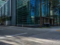 street view of office buildings and parking lot with no curbing at the intersection of city street