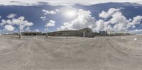 an artistic view shows the empty ground and the building in the background as seen from a fish - eye lens