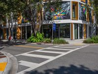 a street corner in front of an open area with a building and tree tops that are all covered in yellow paint