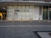 a shopfront with one ocean written on the side of the building at the entrance