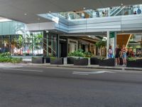 this is an image of a street corner with a stop light and two planters