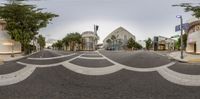 a view from the inside looking at an intersection with buildings and trees on the street