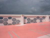 red, white and gray patterns on a roof of a building with a white fence