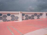 red, white and gray patterns on a roof of a building with a white fence