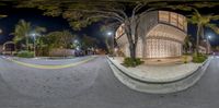 a very wide angle view of an outdoor parking lot area with a building in the background