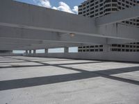 there is an empty parking garage with some windows on it's ceiling and some buildings