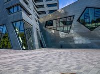 a fire hydrant in the middle of a walkway next to a tall building with two buildings