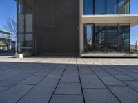 a white building with a walkway and glass windows on the side of it on a sunny day