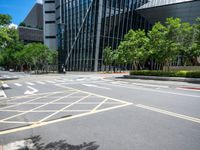 the yellow lines on the street indicate a crosswalk between a street and buildings behind