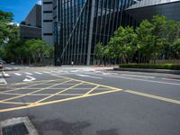 the yellow lines on the street indicate a crosswalk between a street and buildings behind