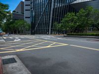 the yellow lines on the street indicate a crosswalk between a street and buildings behind