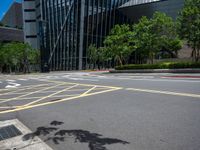 the yellow lines on the street indicate a crosswalk between a street and buildings behind