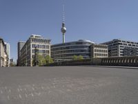 a cityscape with buildings and a sky tower in the background and chalk writing