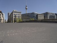 a cityscape with buildings and a sky tower in the background and chalk writing