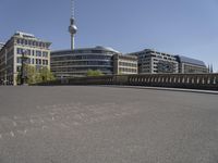 a cityscape with buildings and a sky tower in the background and chalk writing