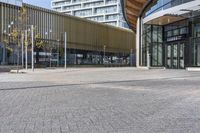 a large building with many windows and a parking area in front of it for walking