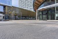 a large building with many windows and a parking area in front of it for walking