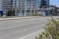 this is the view from the corner of an empty street in front of a large building