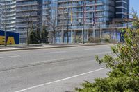 this is the view from the corner of an empty street in front of a large building