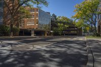 a empty street is surrounded by tall building on a sunny day with no people walking or driving down the sidewalk